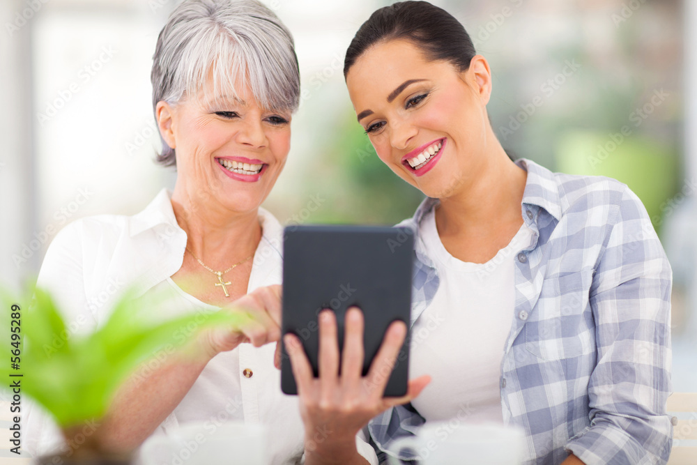 senior mother using tablet computer with daughter senior mother using tablet computer with daughter