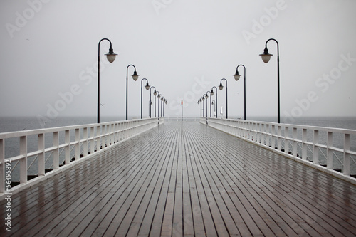 old pier in rain on Baltic sea Orlowo Gdynia Poland #56495892
