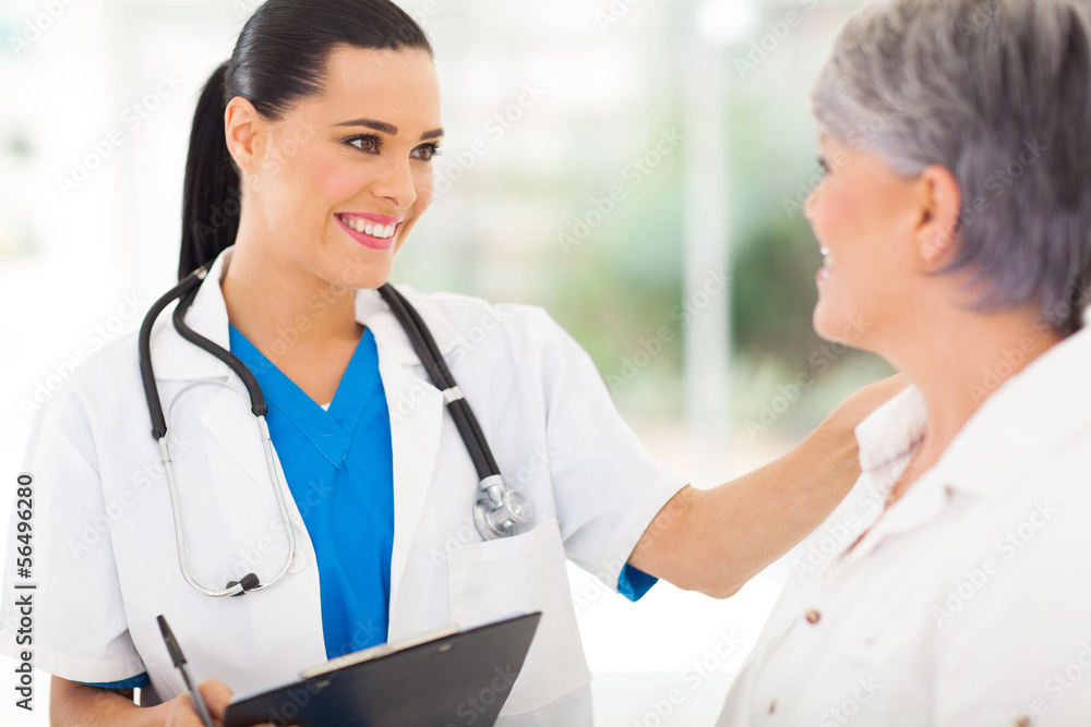 female doctor comforting middle aged patient female doctor comforting middle aged patient