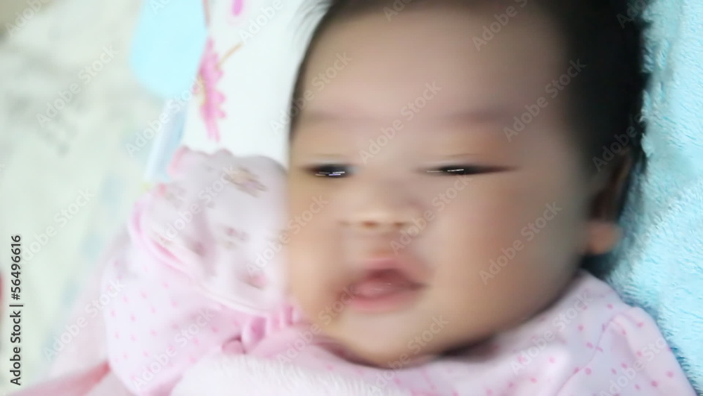 Asian baby playing on the bed Asian baby playing on the bed
