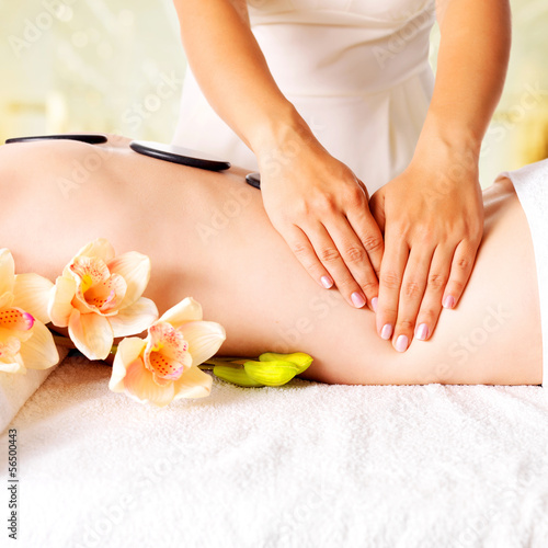 Woman having massage of body in spa salon