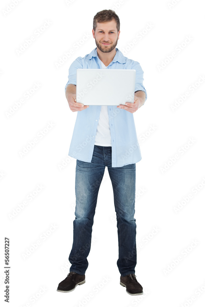 Cheerful man showing laptop to camera and smiling Cheerful man showing laptop to camera and smiling