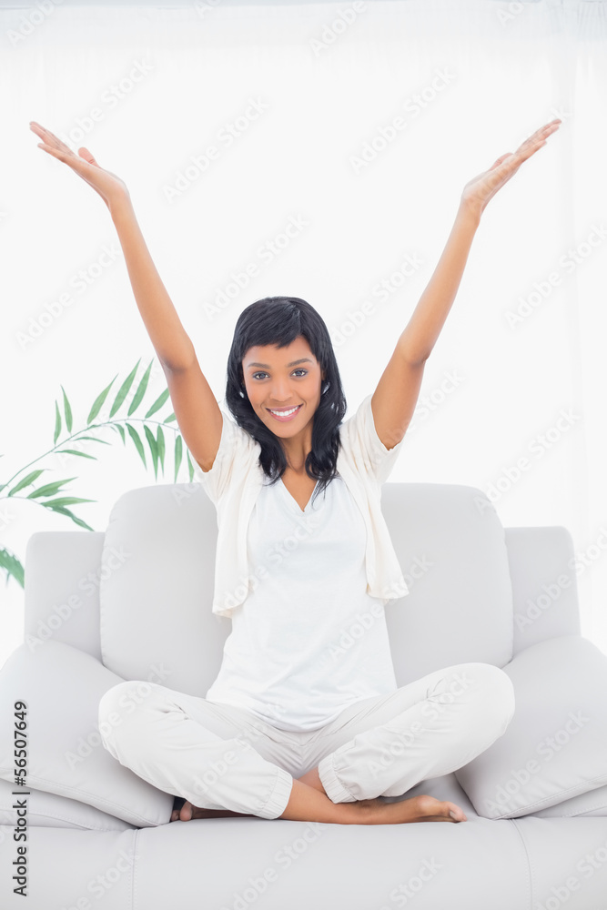 Pleased black haired woman in white clothes raising her arms Pleased black haired woman in white clothes raising her arms