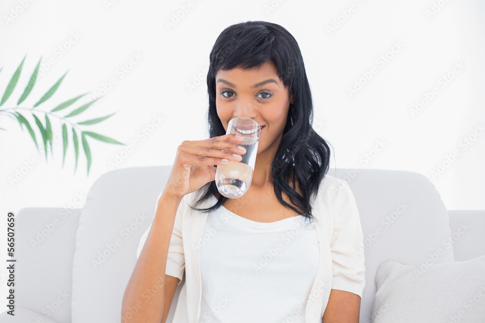 Seductive black haired woman in white clothes drinking water Seductive black haired woman in white clothes drinking water