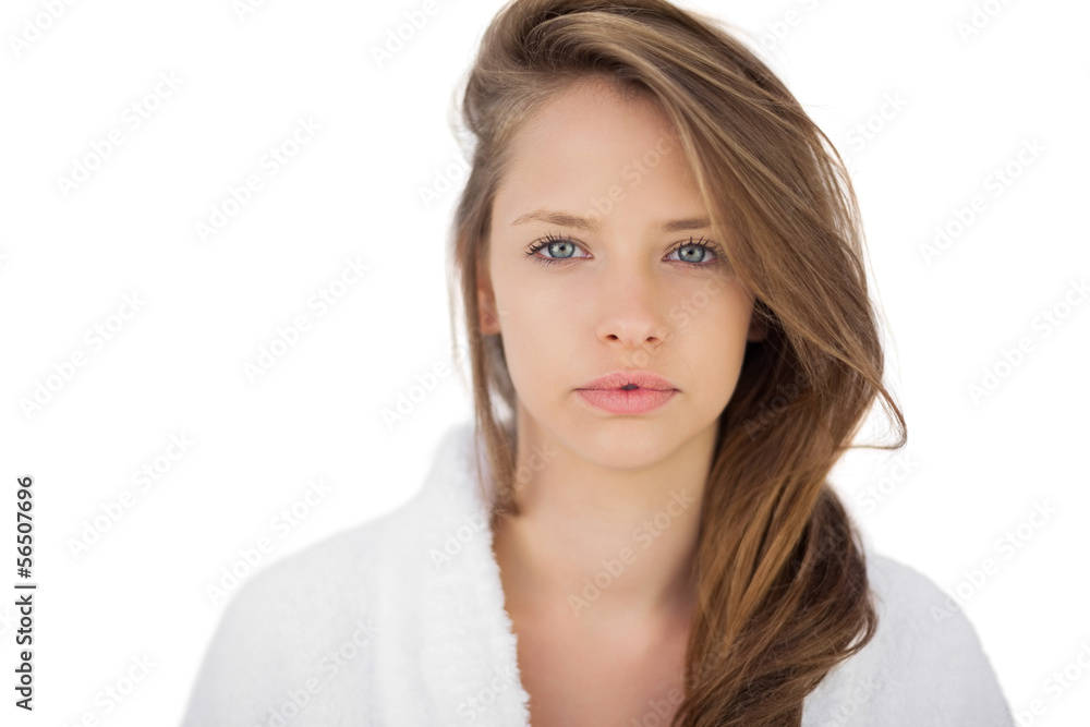 Wondering brunette in bathrobe looking at camera Wondering brunette in bathrobe looking at camera