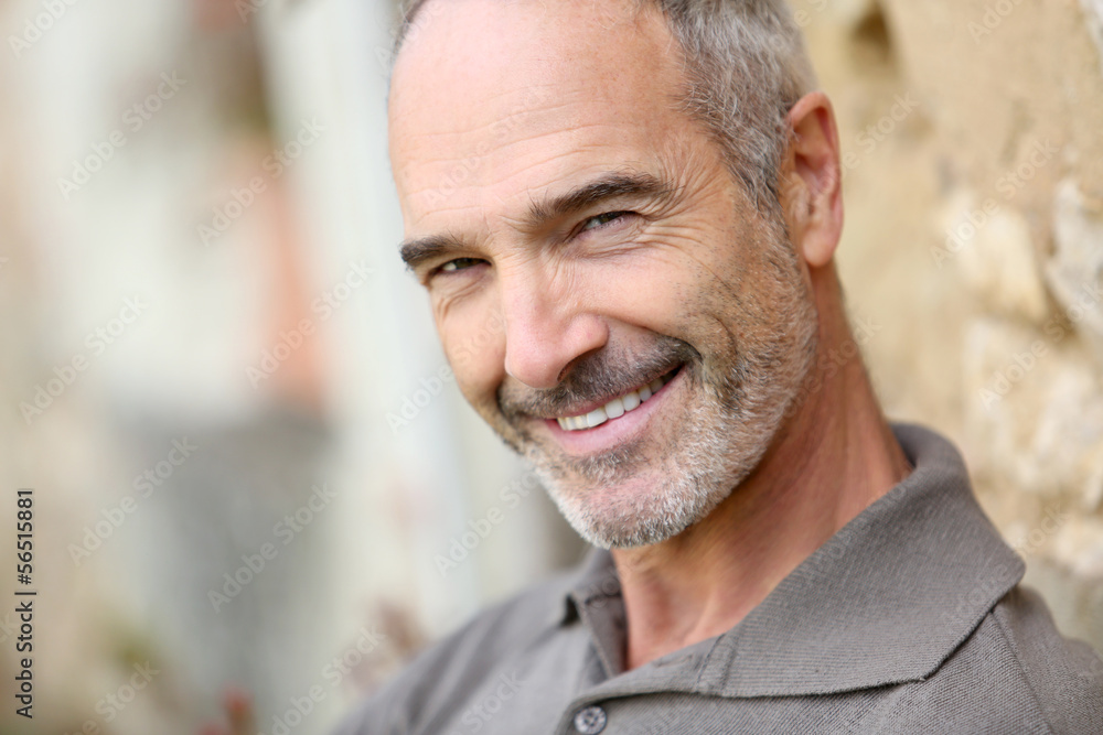 Fototapeta premium Portrait of smiling handsome mature man