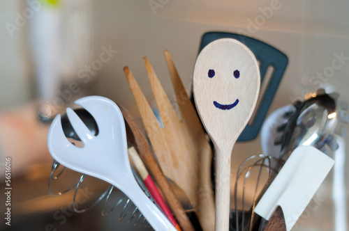 The wooden smiling spoon and kitchen accessories in the kitchen