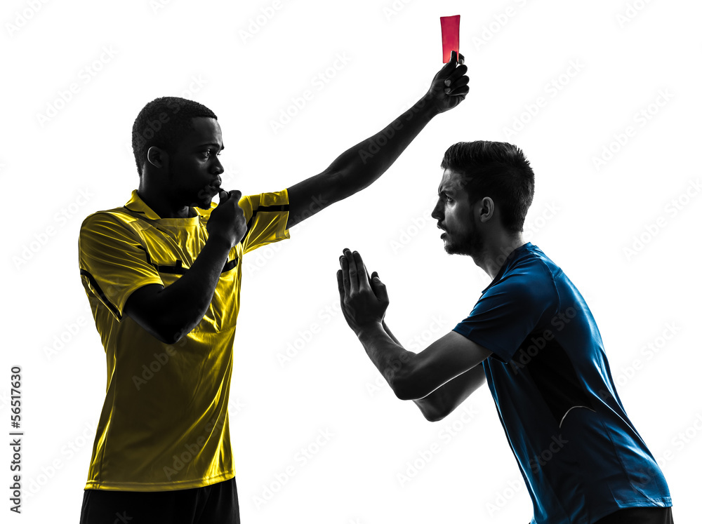 Fototapeta premium two men soccer player and referee showing red card silhouette