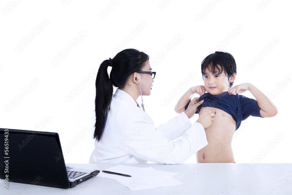 Female doctor auscultating child with a stethoscope Female doctor auscultating child with a stethoscope