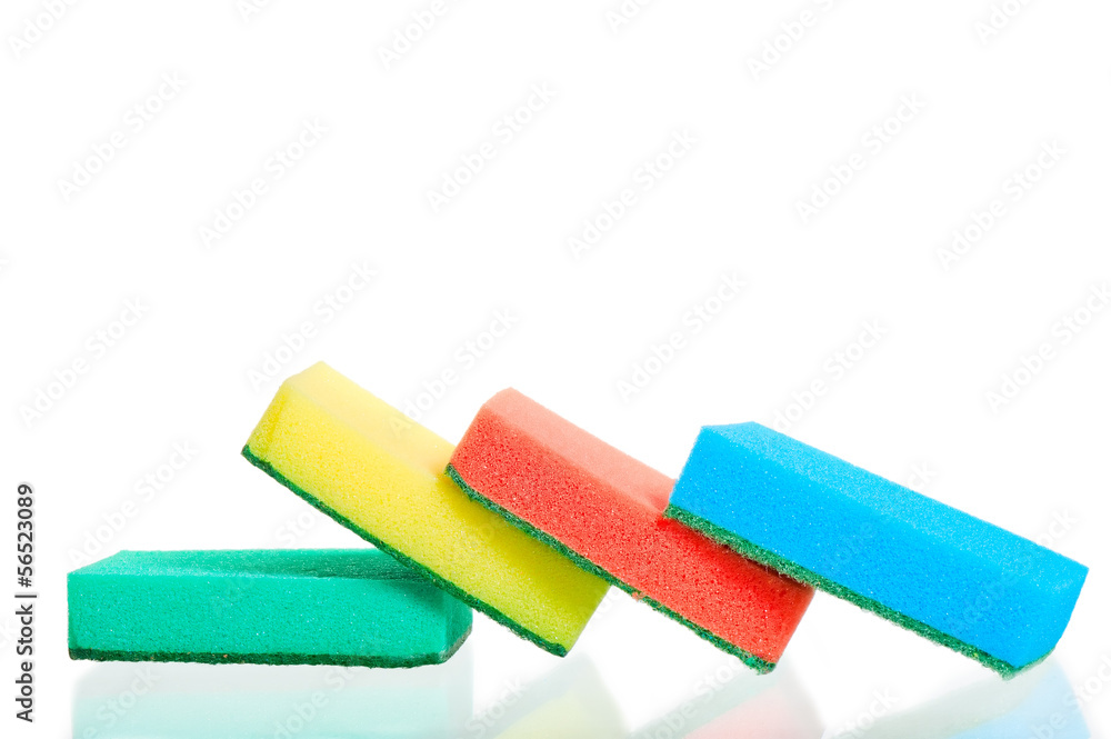 Four multi-colored sponges on white background Four multi-colored sponges on white background