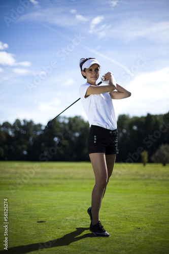 Young woman playing golf 