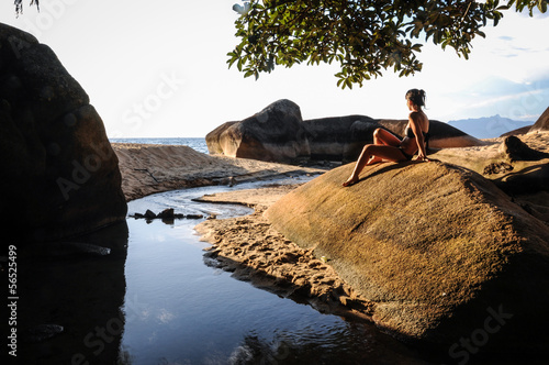 Model enjoying the sunset of the tropical island at Ilha Grande,