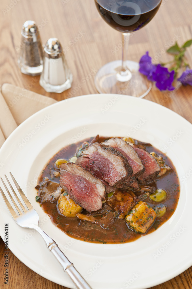 lamb sirloin with herbed gnocchi and glass of wine lamb sirloin with herbed gnocchi and glass of wine