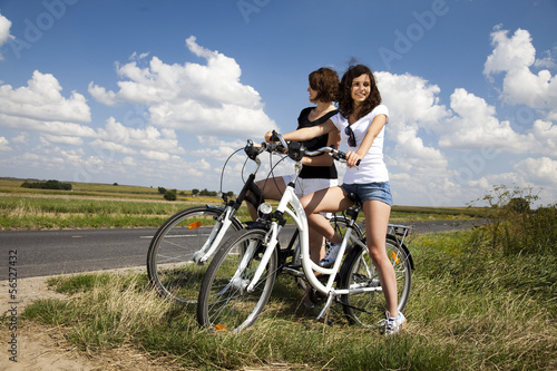 Young girls riding a bicycle 