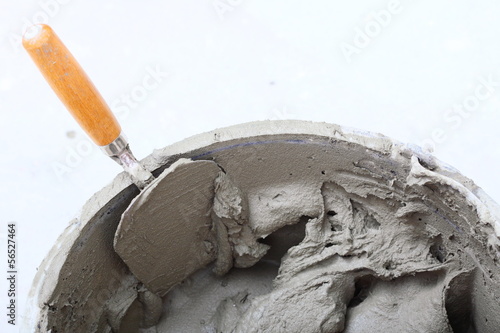 dirty trowel and bucket on building site photo