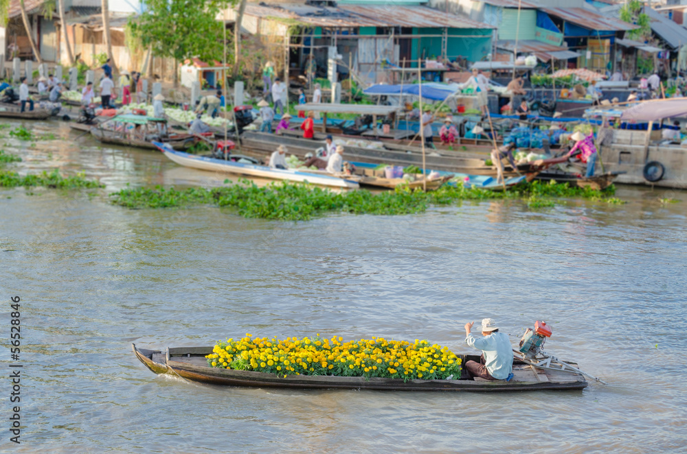 Fototapeta premium The man and colorful flowers boat at Nga Nam floating market, So
