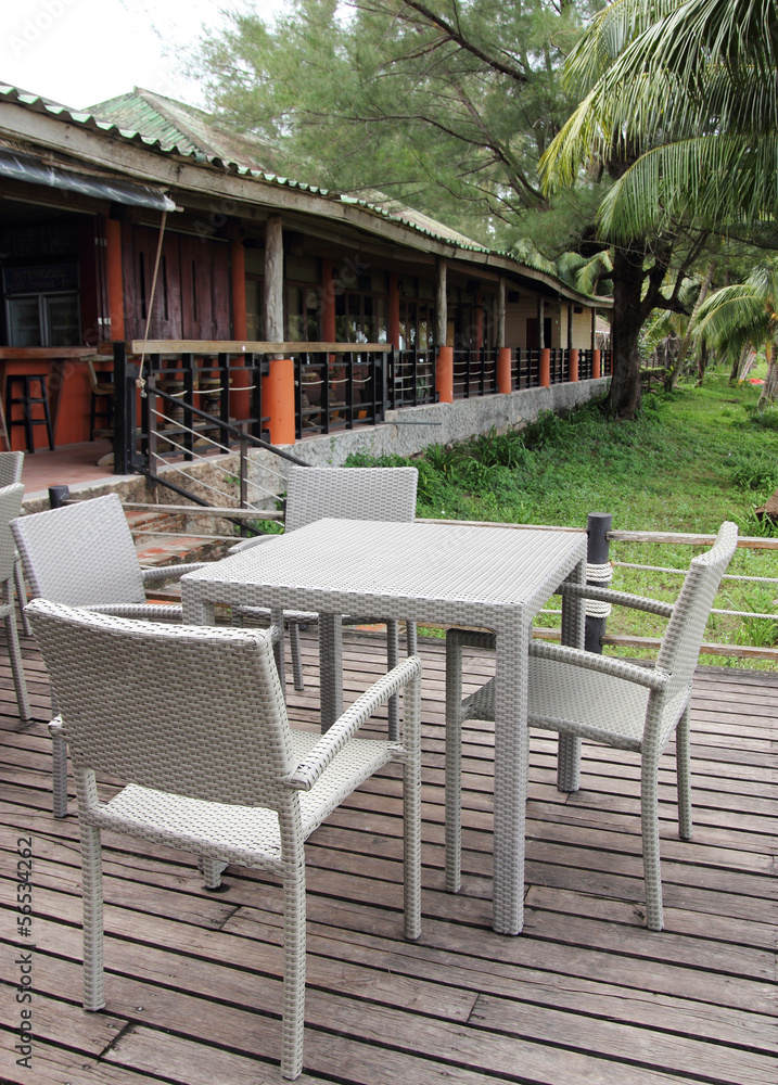 Outdoor restaurant with tables and chairs in resort - obrazy, fototapety, plakaty 