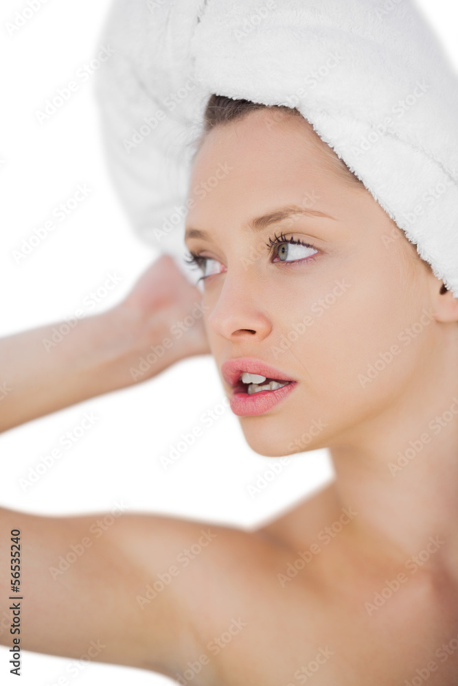 Thoughtful brunette drying her hair looking away Thoughtful brunette drying her hair looking away