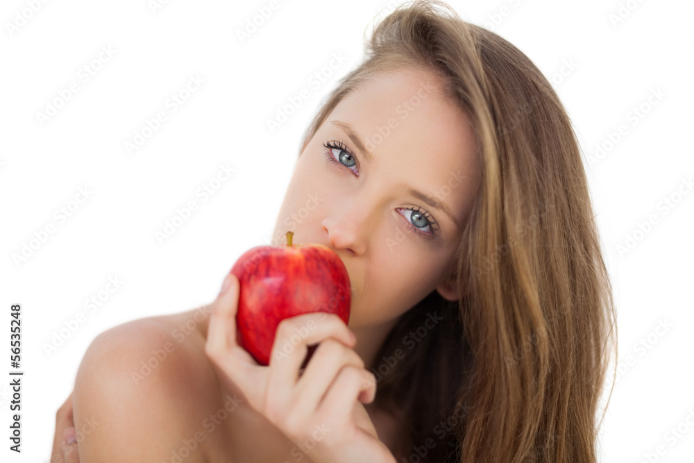 Pensive brunette model eating an apple Pensive brunette model eating an apple