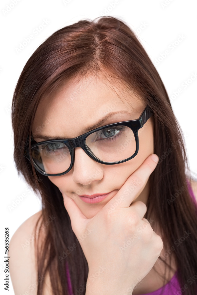 Close up on thoughtful brunette with glasses posing