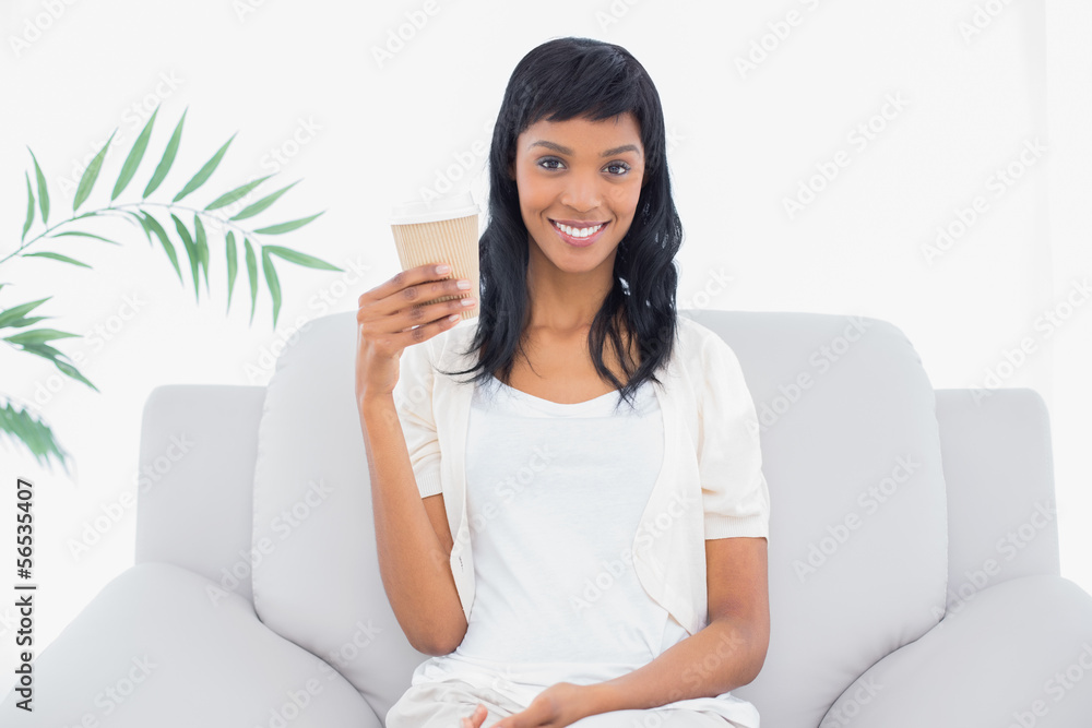Calm black haired woman in white clothes holding a beverage Calm black haired woman in white clothes holding a beverage