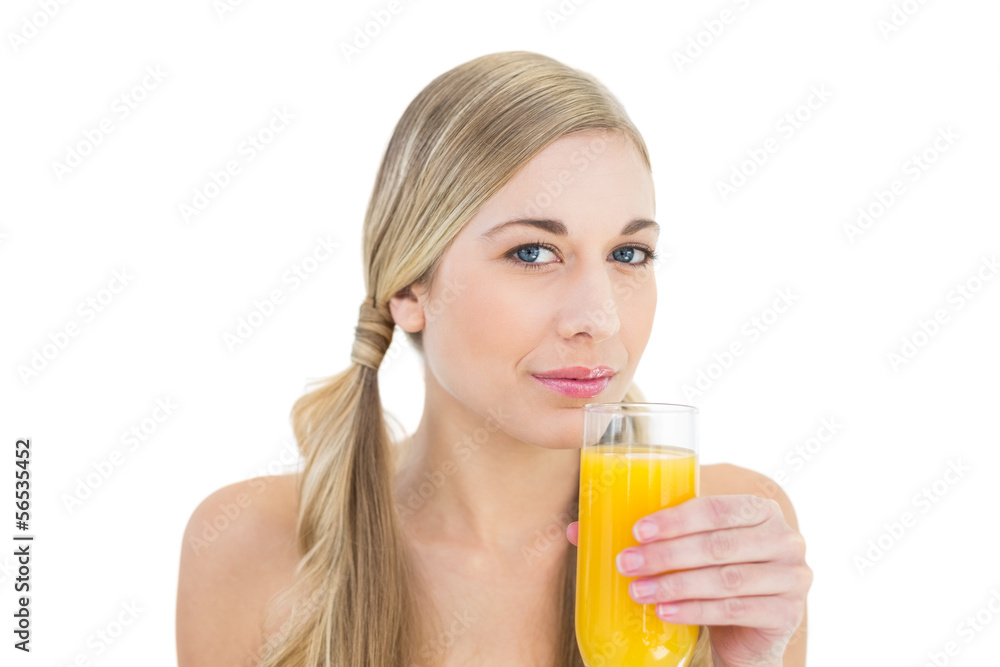 Attractive young blonde woman drinking orange juice Attractive young blonde woman drinking orange juice