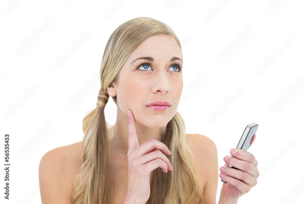 Pensive young blonde woman holding a mobile phone Pensive young blonde woman holding a mobile phone