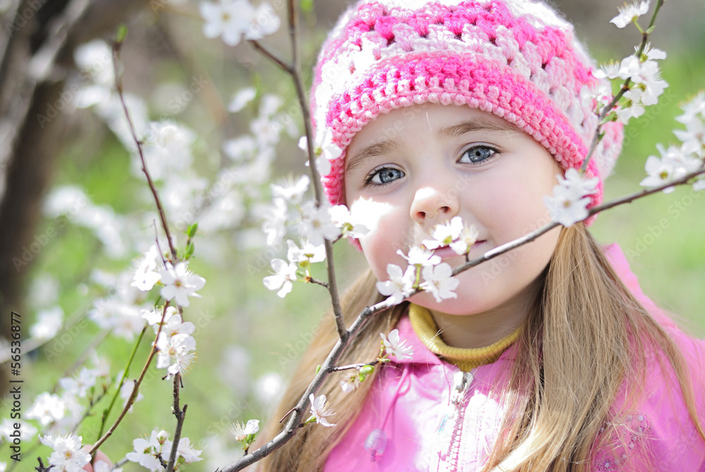 beautiful little girl near a flowering tree beautiful little girl near a flowering tree