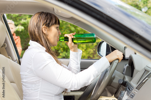 Female motorist drinking and driving © kolotype