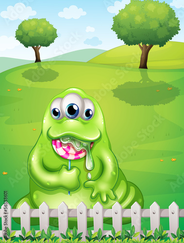 A monster at the hilltop eating a lollipop