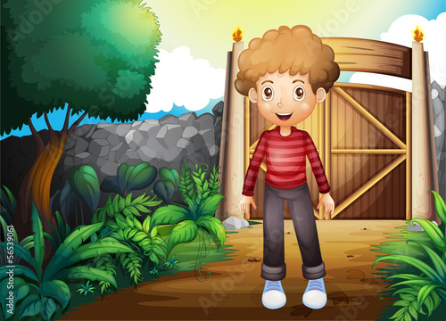 A smiling young boy inside the gated yard