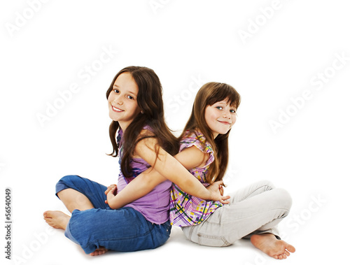 Sisters hugging. Isolated on white background