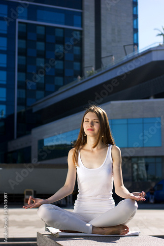 young woman sitting outdoors