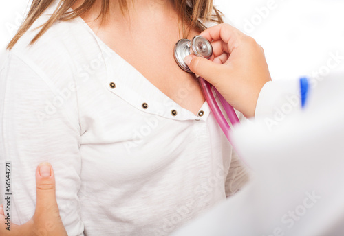 a doctor checking the heart rate of a girl