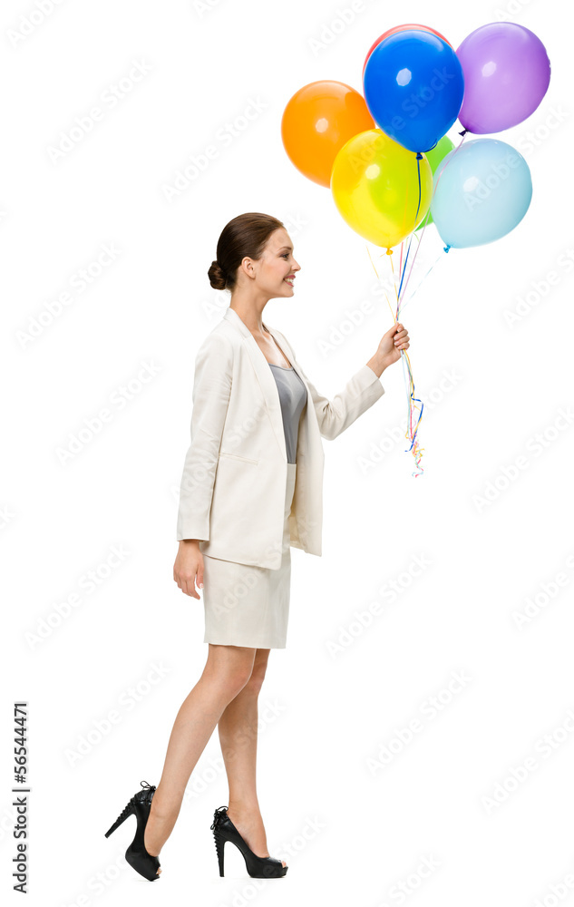 Full-length profile of business woman walking with baloons Full-length profile of business woman walking with baloons