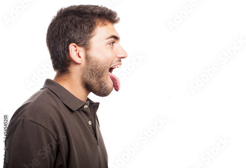 young man showing his tongue on a white background