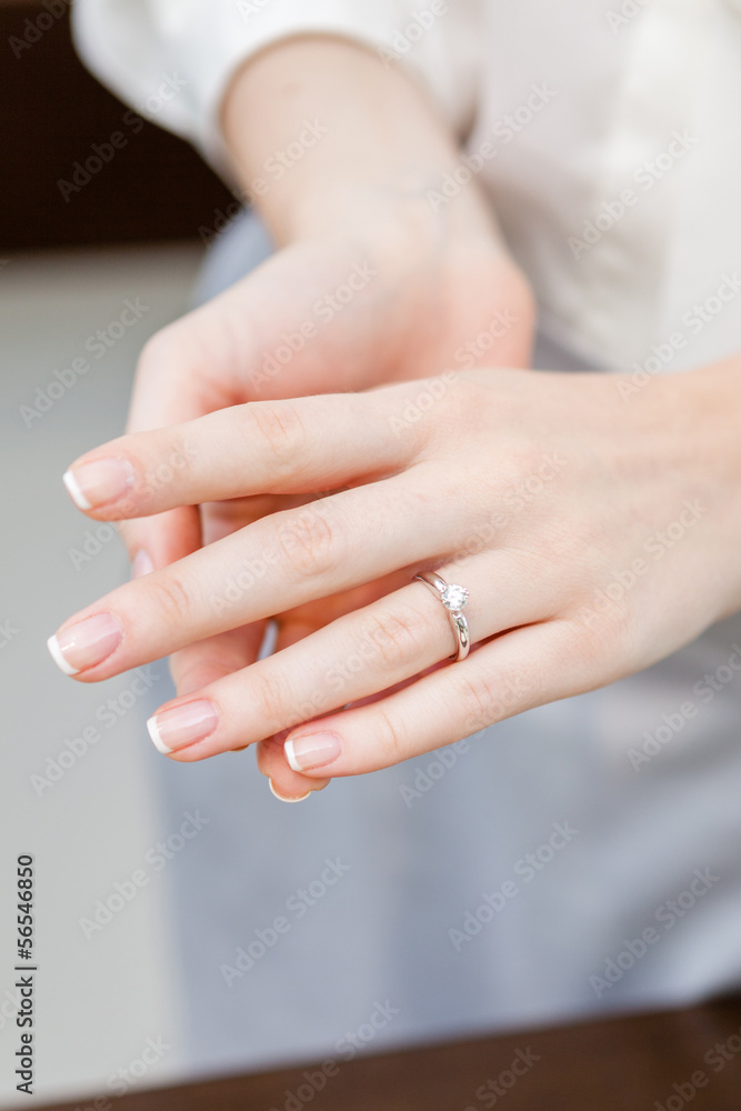Close up of female hands with engagement ring at jeweler's shop Close up of female hands with engagement ring at jeweler's shop