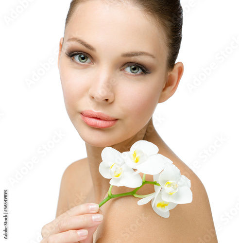 Close up of nude girl handing white orchid