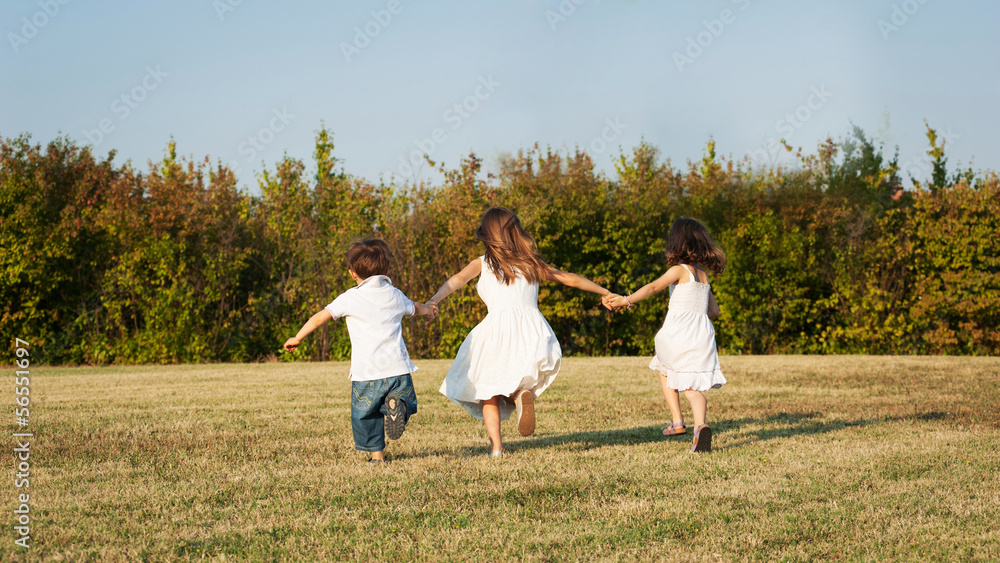 Young kids running together outdoors. Young kids running together outdoors.