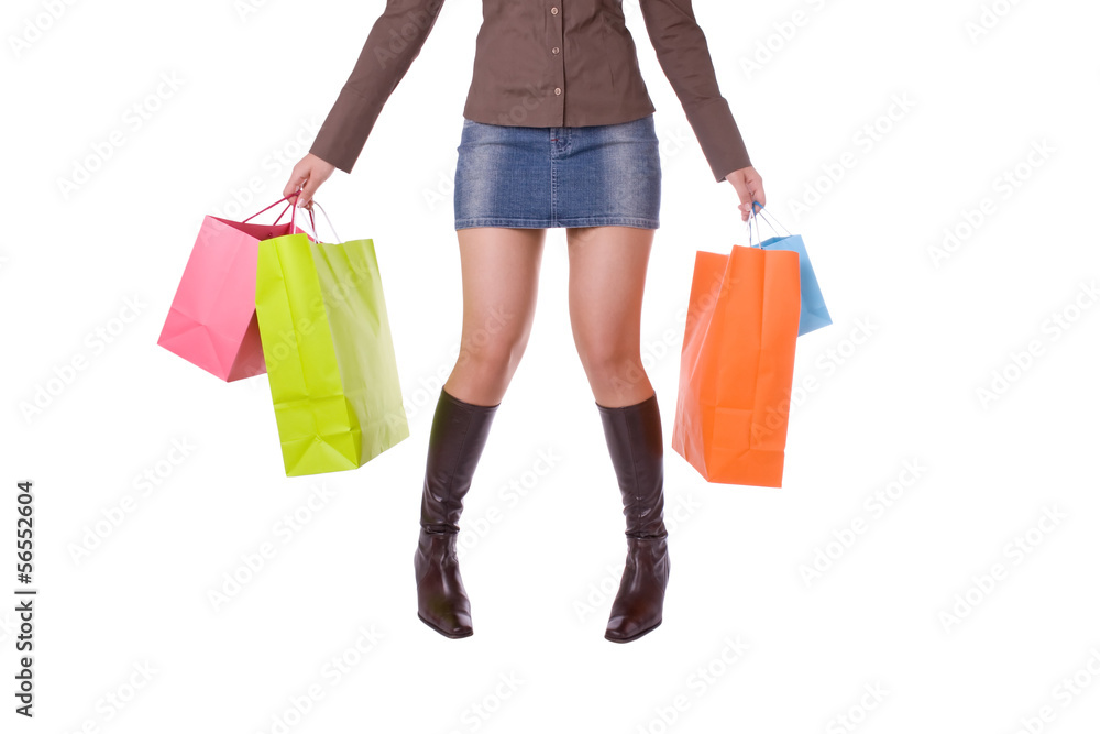 Tired young attractive woman carrying several shopping bags