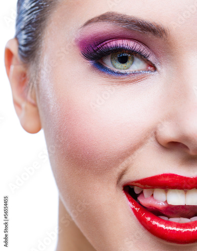 Headshot of female half-face with bright saturated makeup