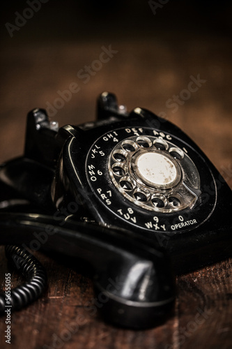 Black vintage telephone on a farm table