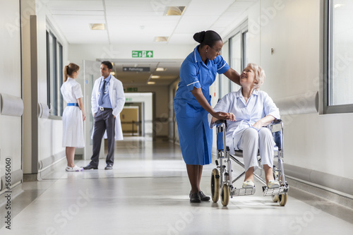 Senior Female Patient in Wheelchair & Nurse in Hospital photo