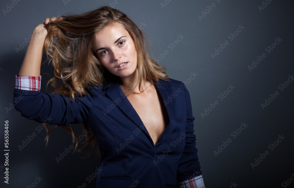 Sexy woman pulls hair, dark background Sexy woman pulls hair, dark background