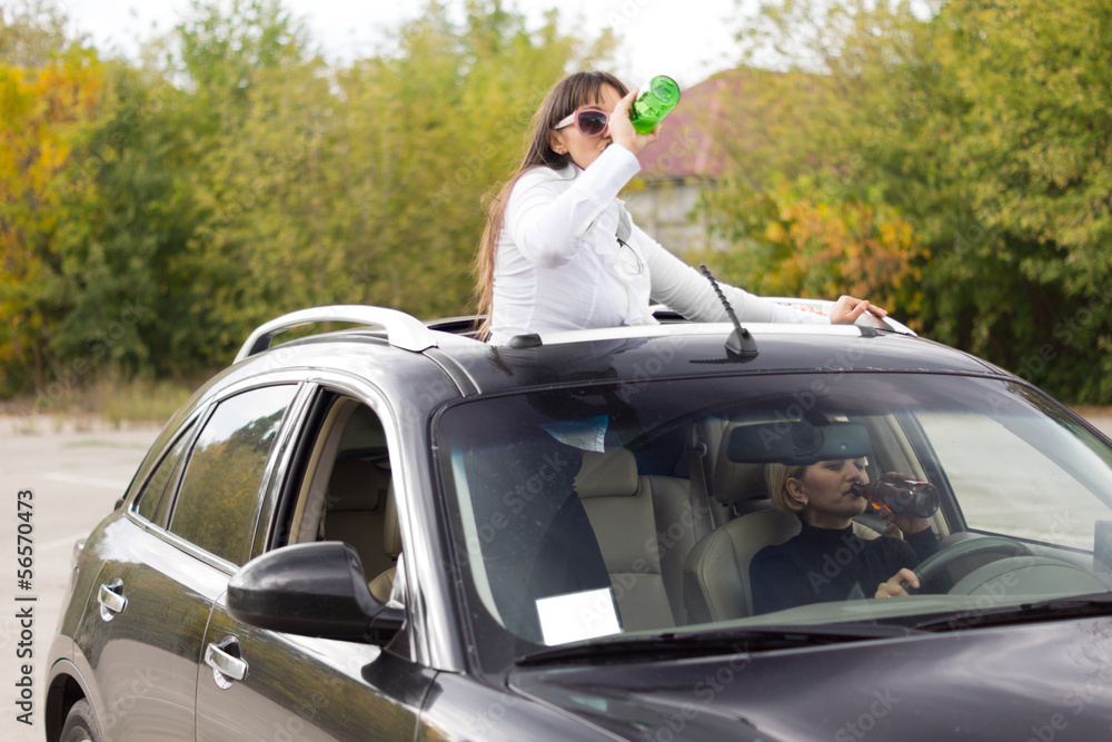 Two women drinking and driving