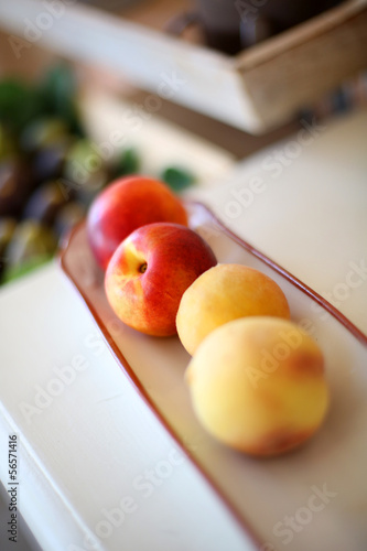 Closeup of fresh peaches set on table