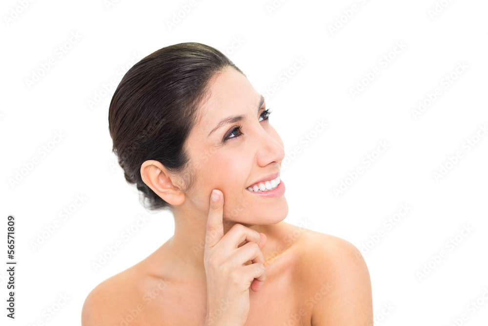 Thoughtful brunette with finger on her face and smiling Thoughtful brunette with finger on her face and smiling
