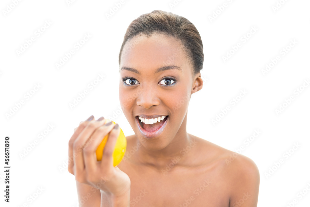 Surprised natural beauty holding orange Surprised natural beauty holding orange