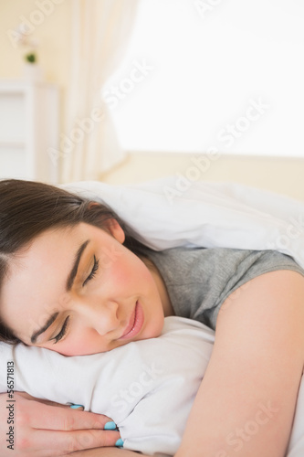 Smiling girl sleeping in her bed