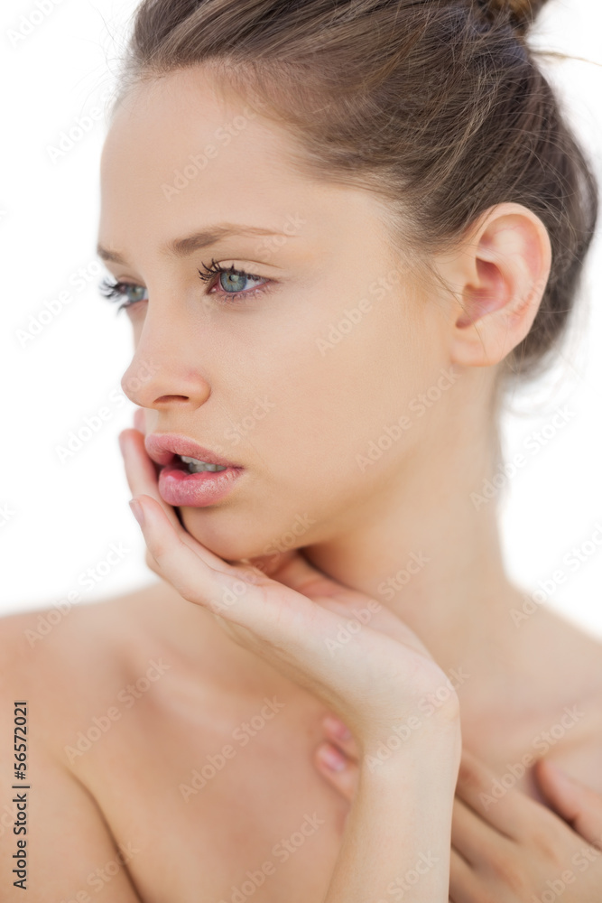 Unsmiling brunette model posing holding her head Unsmiling brunette model posing holding her head